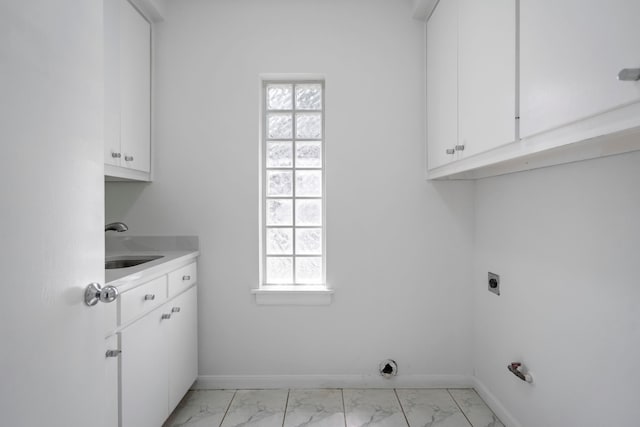 8907 Club Creek Cir, Dallas, TX 75238 - laundry room featuring light marble finish floors, hookup for an electric dryer, and cabinet space