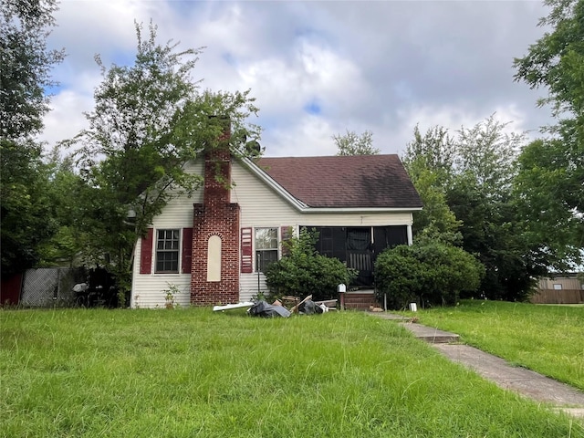 200 1st St, Terrell, TX 75160 - view of front of home featuring a front lawn, a shingled roof, and a chimney