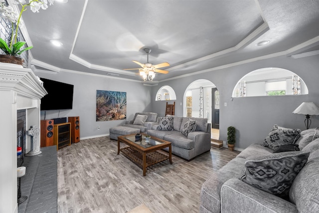 120 Hollie Dr, Red Oak, TX 75154 - living area with a tray ceiling, baseboards, a fireplace, wood finished floors, and ornamental molding
