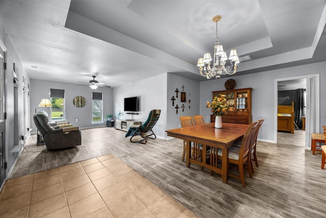 120 Hollie Dr, Red Oak, TX 75154 - dining room featuring a chandelier, baseboards, a tray ceiling, wood finished floors, and a ceiling fan
