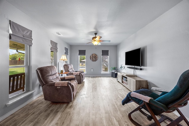 120 Hollie Dr, Red Oak, TX 75154 - living area with wood finished floors, plenty of natural light, and a ceiling fan