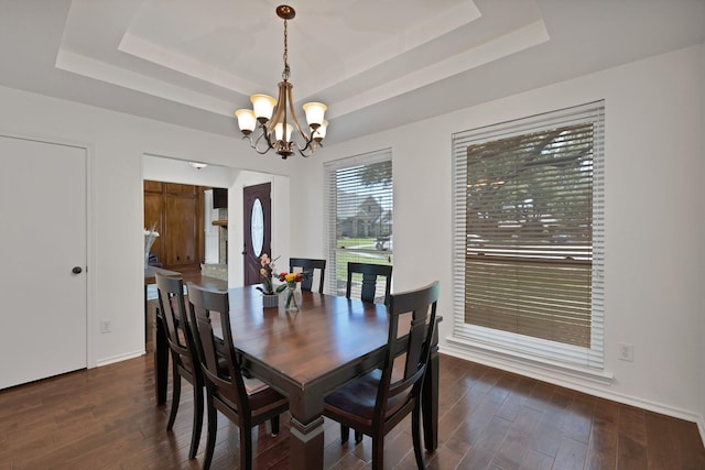 1614 Shadow Moss Way, Carrollton, TX 75007 - dining area featuring a tray ceiling, a chandelier, and dark wood-style flooring