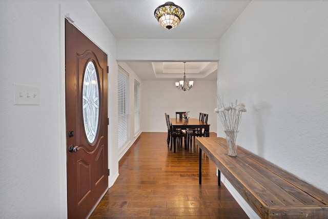 1614 Shadow Moss Way, Carrollton, TX 75007 - entrance foyer featuring a raised ceiling, dark wood-type flooring, and a chandelier