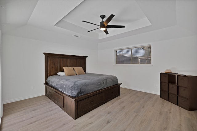 1614 Shadow Moss Way, Carrollton, TX 75007 - bedroom with a tray ceiling, light wood-style floors, and a ceiling fan