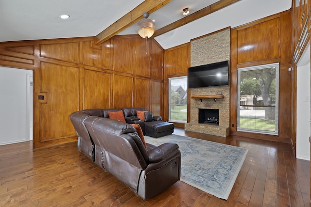 1614 Shadow Moss Way, Carrollton, TX 75007 - living room with a stone fireplace, plenty of natural light, dark wood finished floors, and wood walls