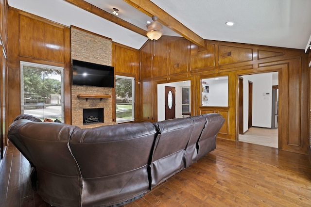1614 Shadow Moss Way, Carrollton, TX 75007 - living room featuring hardwood / wood-style flooring, plenty of natural light, wood walls, and a fireplace