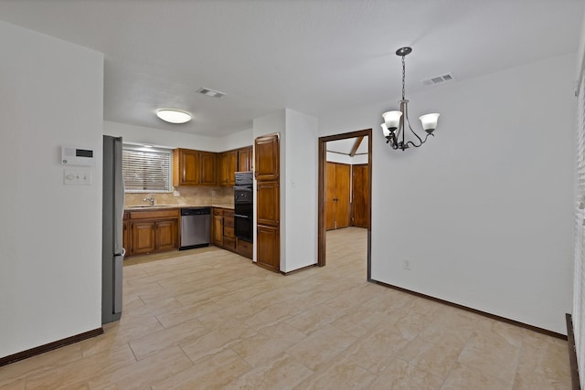 1614 Shadow Moss Way, Carrollton, TX 75007 - kitchen with stainless steel appliances, brown cabinets, a chandelier, backsplash, and pendant lighting