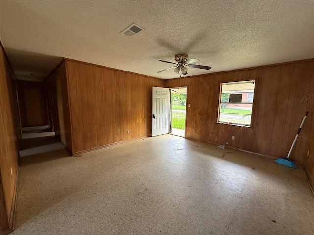 430 Cranford St, Sulphur Springs, TX 75482 - unfurnished room featuring wooden walls, a ceiling fan, a textured ceiling, and baseboards