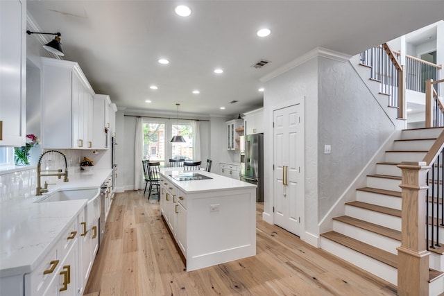 3916 Boulton Ct, Plano, TX 75025 - kitchen with high end fridge, a kitchen island, black electric cooktop, a sink, and recessed lighting
