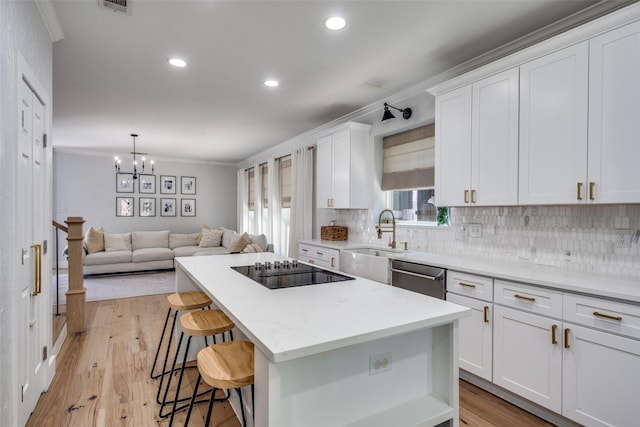 3916 Boulton Ct, Plano, TX 75025 - kitchen featuring black electric cooktop, a sink, stainless steel dishwasher, tasteful backsplash, and crown molding