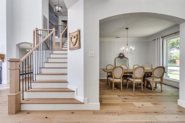 3916 Boulton Ct, Plano, TX 75025 - stairs featuring arched walkways, wood finished floors, plenty of natural light, and crown molding