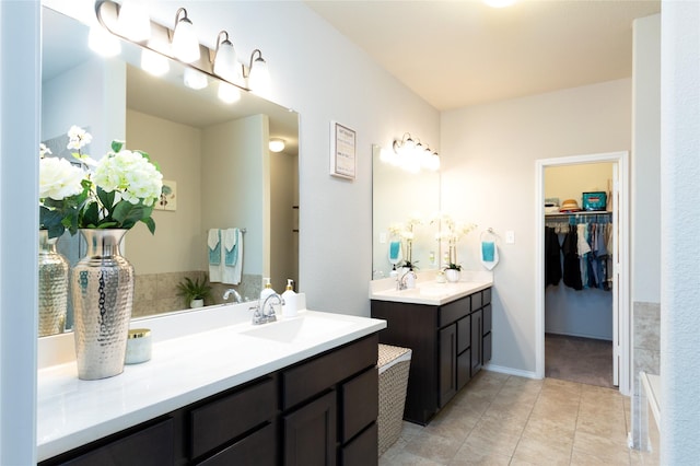 2400 Prairie Trail Ave, Aubrey, TX 76227 - bathroom with two vanities, tile patterned flooring, and a spacious closet