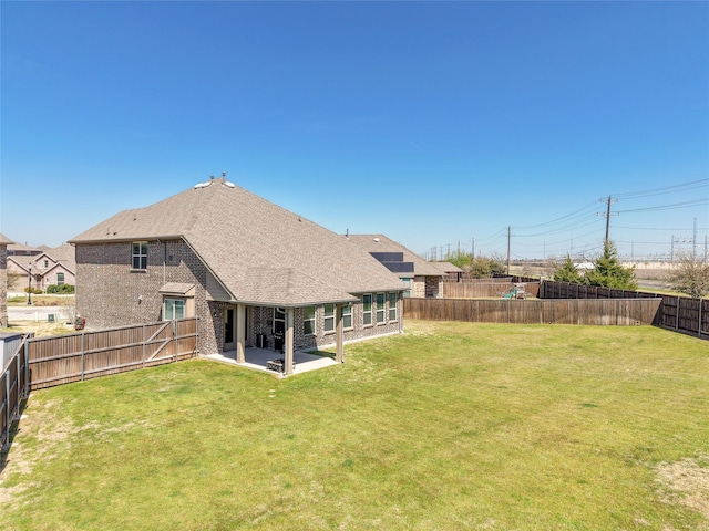 2400 Prairie Trail Ave, Aubrey, TX 76227 - back of house with brick siding, a patio area, and roof with shingles