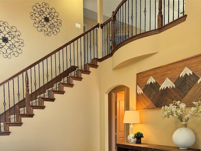 1801 Monaco Dr, Corinth, TX 76210 - stairway featuring arched walkways and a high ceiling
