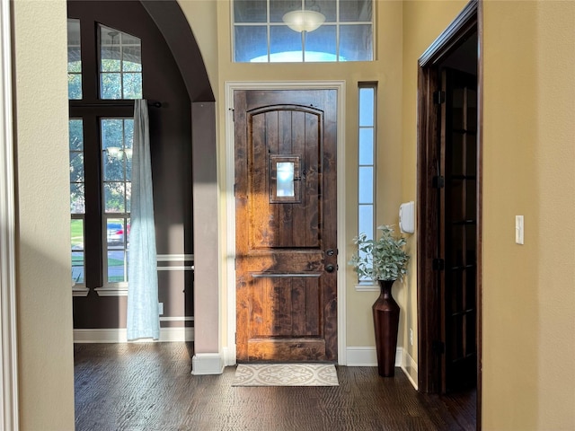 1801 Monaco Dr, Corinth, TX 76210 - entrance foyer with dark wood finished floors, arched walkways, and baseboards