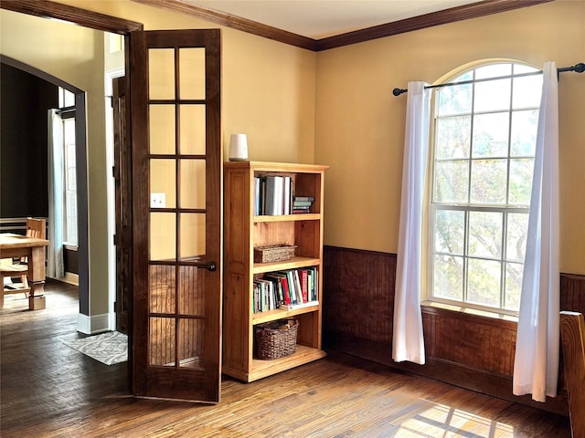 1801 Monaco Dr, Corinth, TX 76210 - living area with arched walkways, wood finished floors, healthy amount of natural light, wainscoting, and crown molding