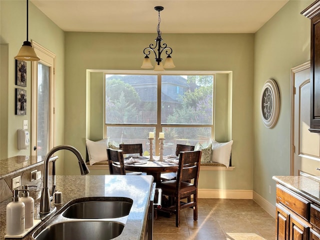 1801 Monaco Dr, Corinth, TX 76210 - dining area featuring a chandelier, baseboards, and light tile patterned floors