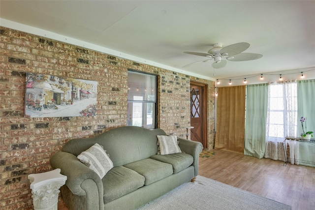 366 W Blackjack St, Dublin, TX 76446 - living room with a ceiling fan, wood finished floors, and brick wall