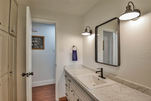 366 W Blackjack St, Dublin, TX 76446 - bathroom featuring vanity, wood finished floors, and baseboards