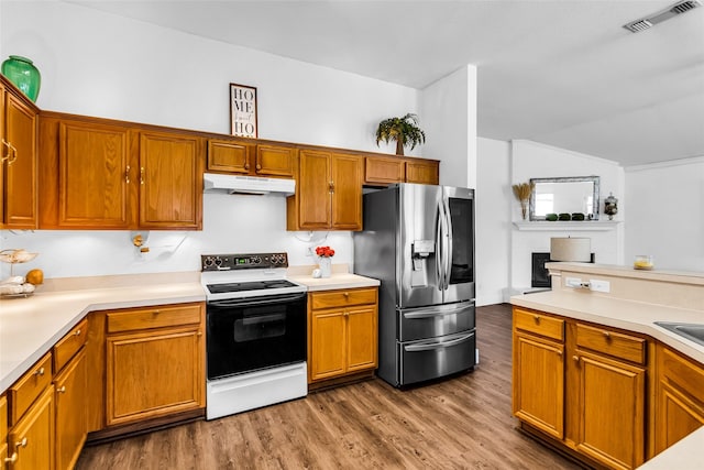 432 Maplegrove Rd, Cedar Hill, TX 75104 - kitchen with electric stove, stainless steel fridge, under cabinet range hood, wood finished floors, and light countertops