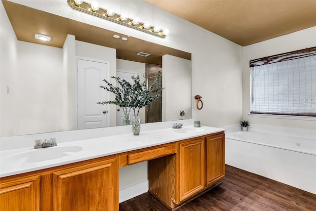 432 Maplegrove Rd, Cedar Hill, TX 75104 - full bath with double vanity, a garden tub, and wood finished floors