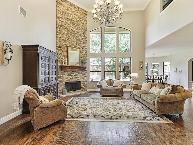 701 Buffalo Springs Dr, Prosper, TX 75078 - living room featuring a chandelier, wood finished floors, a high ceiling, a fireplace, and baseboards