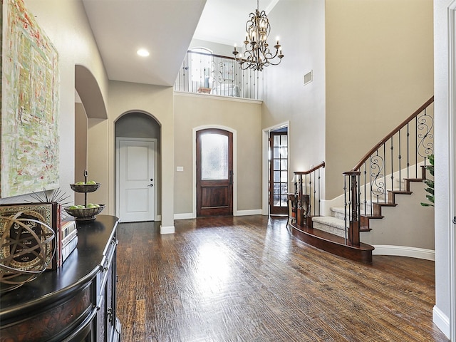 701 Buffalo Springs Dr, Prosper, TX 75078 - entryway featuring a chandelier, arched walkways, stairway, wood finished floors, and baseboards