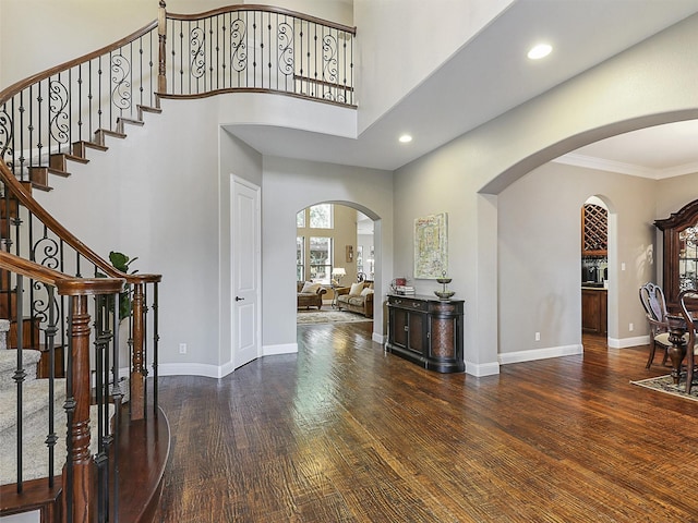 701 Buffalo Springs Dr, Prosper, TX 75078 - foyer entrance with arched walkways, wood finished floors, stairs, baseboards, and a high ceiling