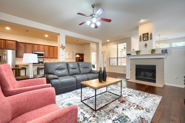 10520 Sexton Dr, Mckinney, TX 75072 - living area with ceiling fan, dark wood finished floors, baseboards, a tiled fireplace, and recessed lighting