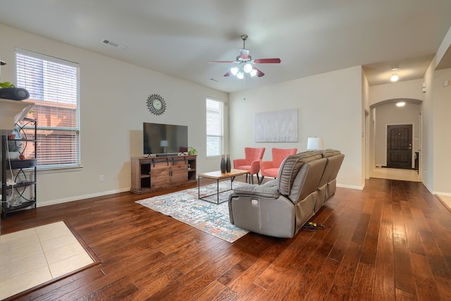 10520 Sexton Dr, Mckinney, TX 75072 - living room featuring a ceiling fan, wood-type flooring, arched walkways, and baseboards