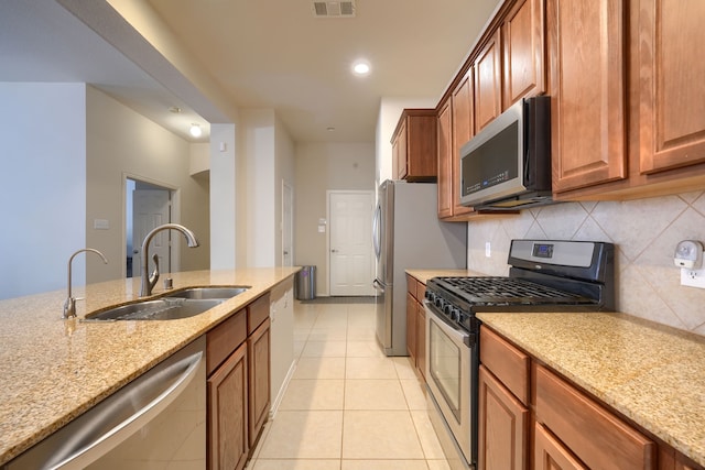 10520 Sexton Dr, Mckinney, TX 75072 - kitchen featuring appliances with stainless steel finishes, a sink, decorative backsplash, light stone counters, and recessed lighting