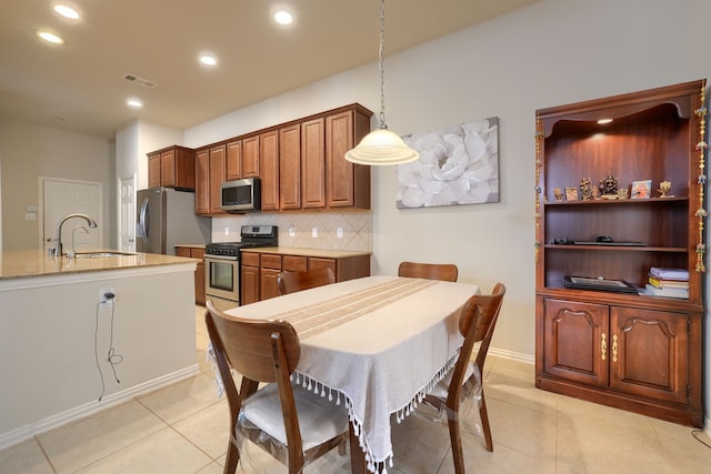 10520 Sexton Dr, Mckinney, TX 75072 - kitchen with appliances with stainless steel finishes, a sink, decorative backsplash, light tile patterned floors, and recessed lighting
