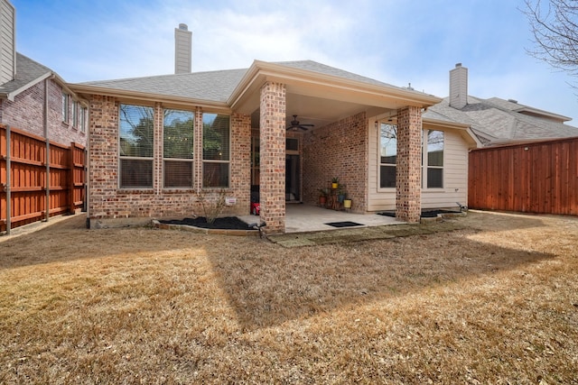 10520 Sexton Dr, Mckinney, TX 75072 - back of house with a ceiling fan, brick siding, a patio, a chimney, and roof with shingles