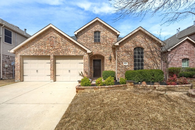 10520 Sexton Dr, Mckinney, TX 75072 - view of front of home with brick siding, an attached garage, and driveway