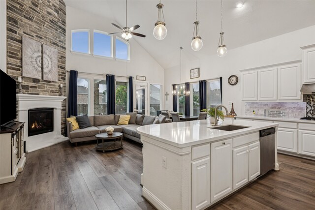 3909 Shrike Trl, Fort Worth, TX 76262 - kitchen with a sink, dishwasher, high vaulted ceiling, open floor plan, and a large fireplace