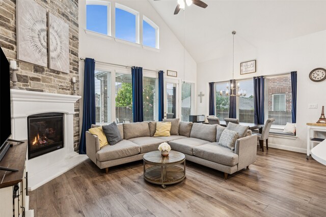 3909 Shrike Trl, Fort Worth, TX 76262 - living area with high vaulted ceiling, a chandelier, a ceiling fan, wood finished floors, and a fireplace