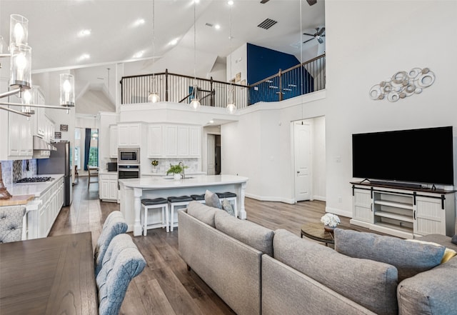 3909 Shrike Trl, Fort Worth, TX 76262 - living room with high vaulted ceiling, a ceiling fan, wood finished floors, baseboards, and recessed lighting