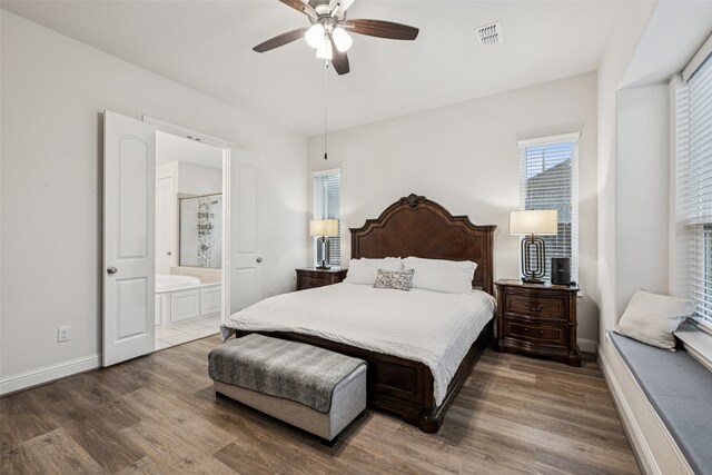 3909 Shrike Trl, Fort Worth, TX 76262 - bedroom with wood finished floors, baseboards, ensuite bath, and a ceiling fan