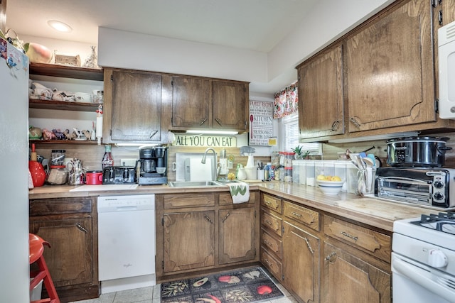 201 S Lake Dallas Dr, Lake Dallas, TX 75065 - kitchen featuring white appliances, a sink, light countertops, open shelves, and brown cabinets