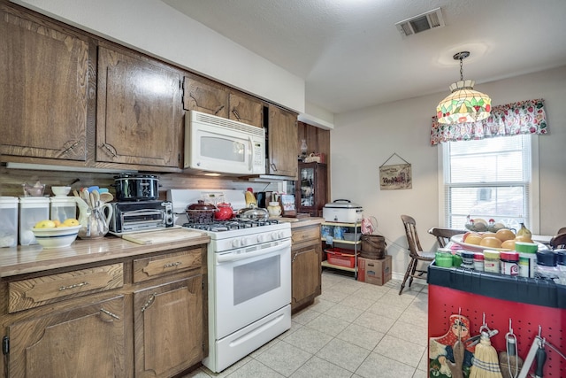 201 S Lake Dallas Dr, Lake Dallas, TX 75065 - kitchen featuring white appliances, light countertops, and pendant lighting
