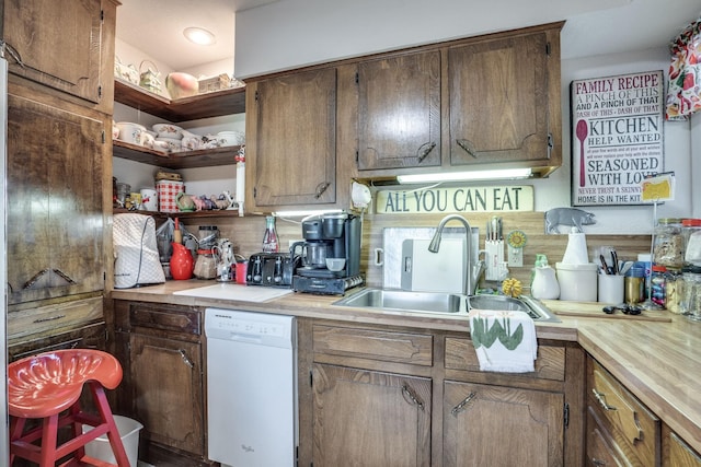 201 S Lake Dallas Dr, Lake Dallas, TX 75065 - kitchen featuring white dishwasher, a sink, light countertops, and open shelves