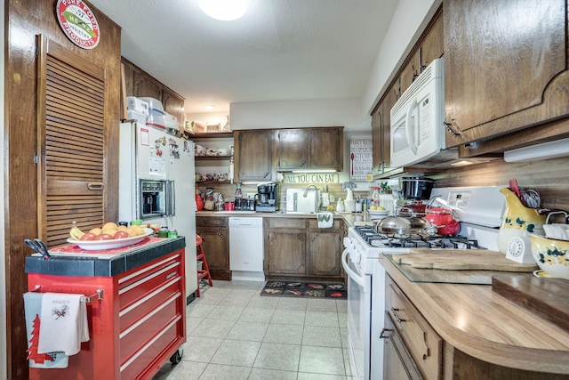 201 S Lake Dallas Dr, Lake Dallas, TX 75065 - kitchen with white appliances, light countertops, open shelves, and a sink