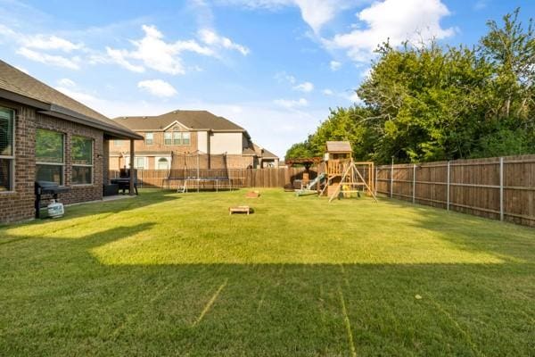 104 Laurel Oak Dr, Red Oak, TX 75154 - view of yard with a trampoline and a playground