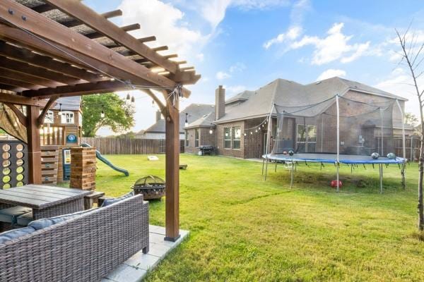 104 Laurel Oak Dr, Red Oak, TX 75154 - view of yard with a trampoline, an outdoor fire pit, a playground, and a pergola