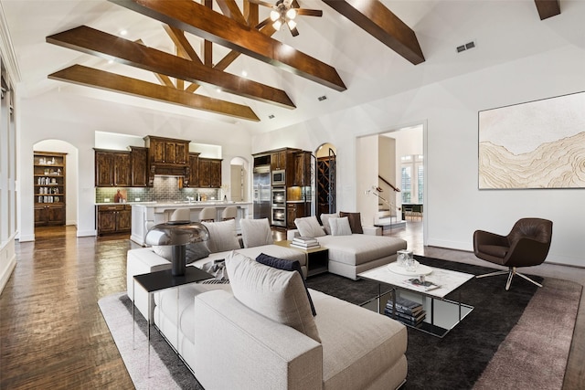 3708 Ledgestone Ct, Richardson, TX 75082 - living room with arched walkways, beamed ceiling, stairs, a ceiling fan, and high vaulted ceiling