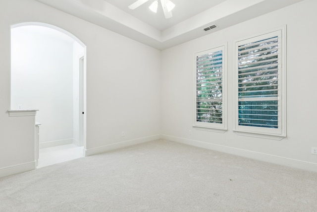 3708 Ledgestone Ct, Richardson, TX 75082 - empty room featuring carpet, arched walkways, a ceiling fan, and a raised ceiling