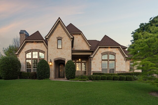 3708 Ledgestone Ct, Richardson, TX 75082 - french country style house with stone siding, a yard, a chimney, and brick siding