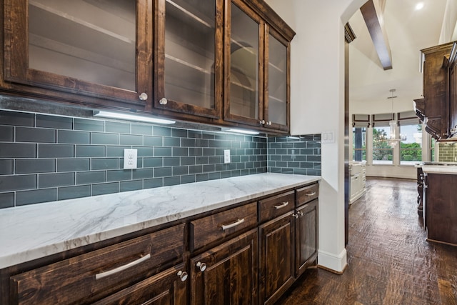 3708 Ledgestone Ct, Richardson, TX 75082 - kitchen featuring dark brown cabinets, light stone counters, tasteful backsplash, and glass insert cabinets