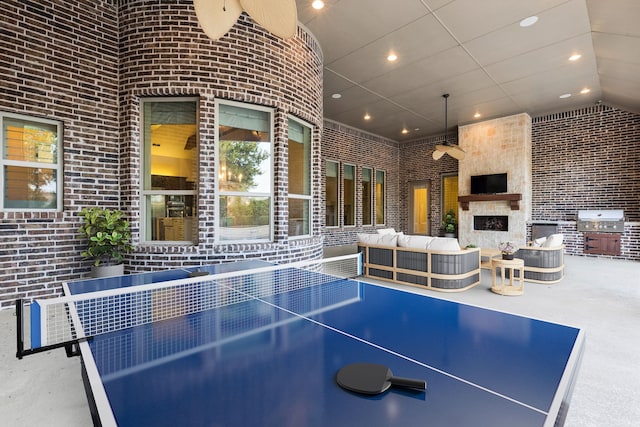 3708 Ledgestone Ct, Richardson, TX 75082 - playroom featuring brick wall, high vaulted ceiling, recessed lighting, and a large fireplace