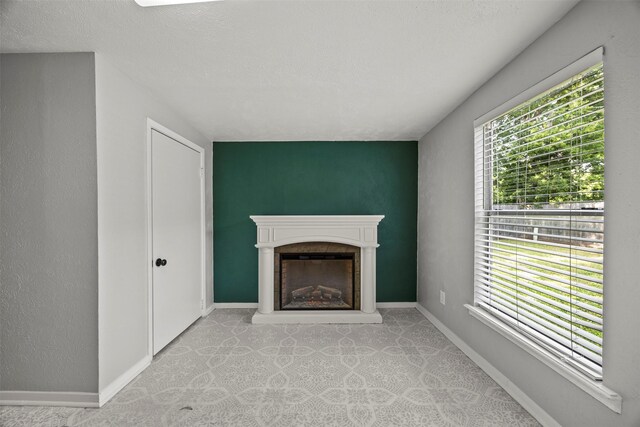 512 Judith St, Burleson, TX 76028 - unfurnished living room featuring a fireplace with raised hearth and baseboards